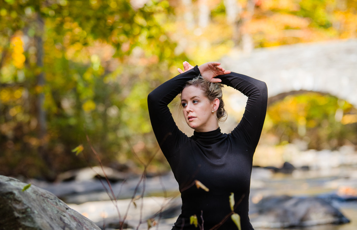 Dance instructor against an autumn backdrop