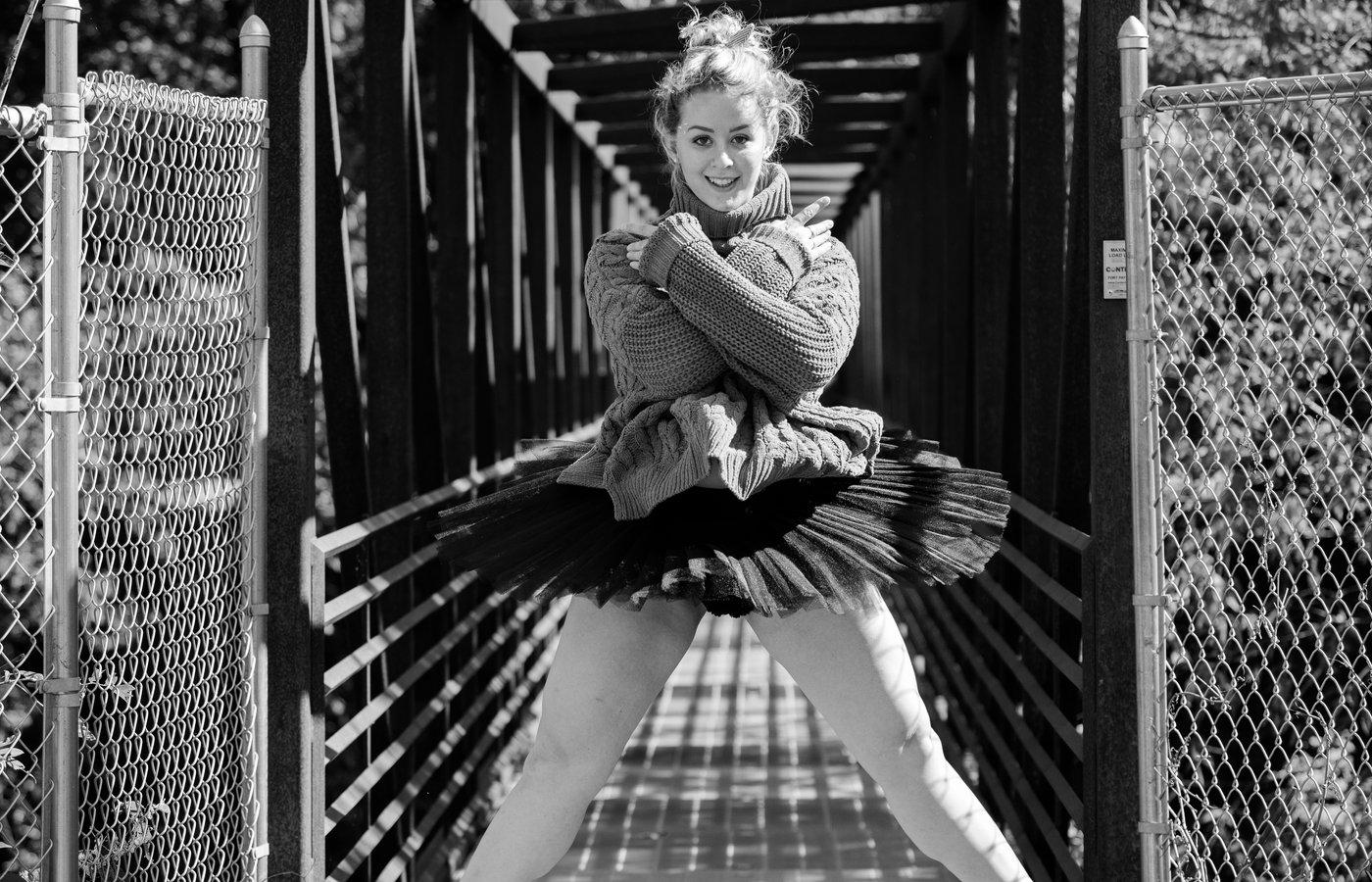 Dancer on footbridge in tutu and sweater